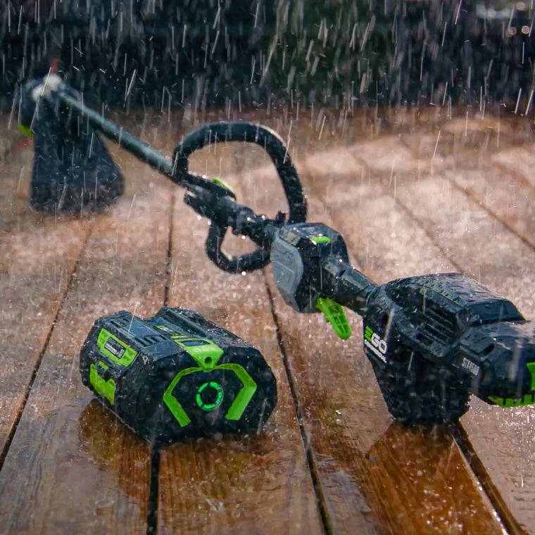 EGO Commercial tool and 56V ARC Lithium™ on a deck in a rainstorm