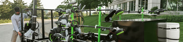 Man loading EGO Commercial equipment onto a landscaping trailer